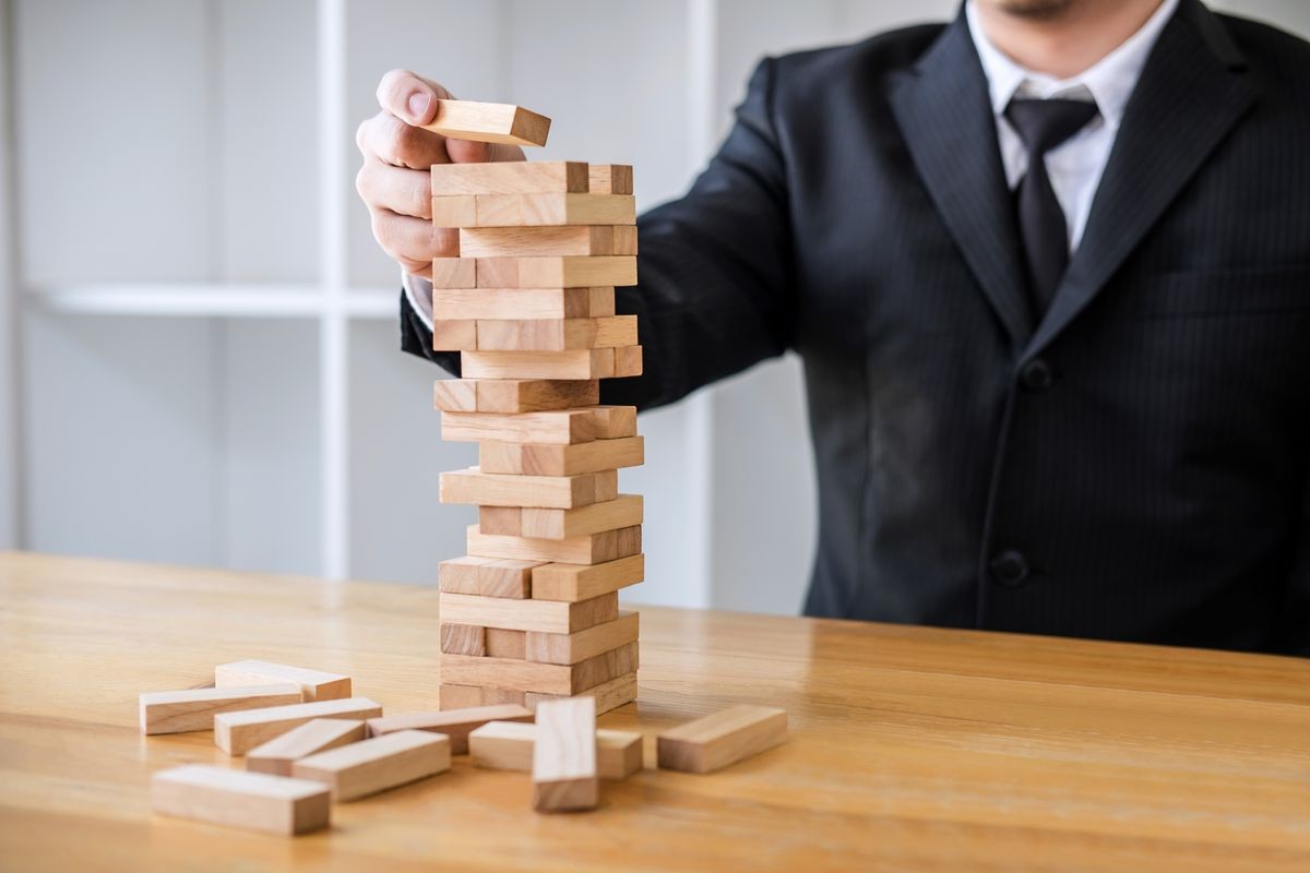 Alternative risk concept, plan and strategy in business, Risk To Make Business Growth Concept With Wooden Blocks, Images of hand of business people placing and pulling wood block on the tower.