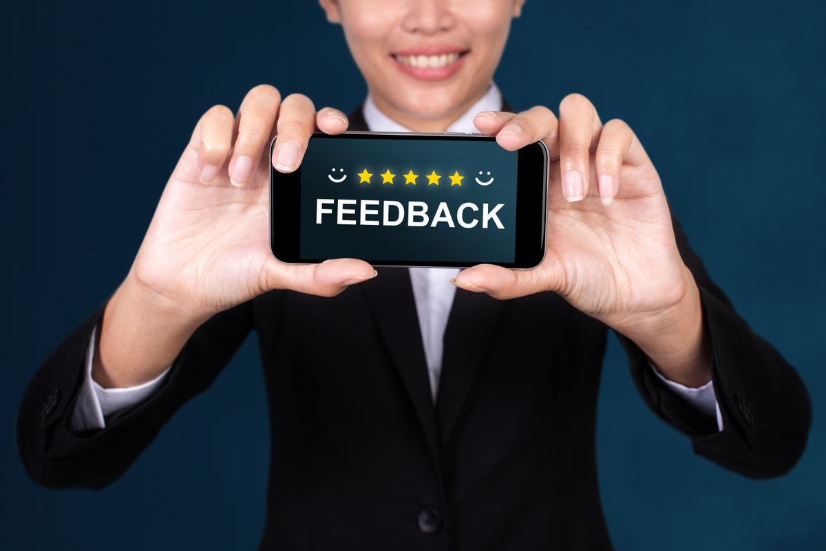 Feedback concept, Happy businesswoman Show text Feedback on Smart Phone.